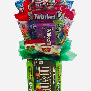 Peut inclure: Un bouquet de bonbons avec une variété de friandises, dont des Twizzlers, Mike and Ike, M&M's et des bonbons Jelly Belly. L'arrangement est enveloppé de papier de soie vert et comprend des bonbons et des sucettes colorés.