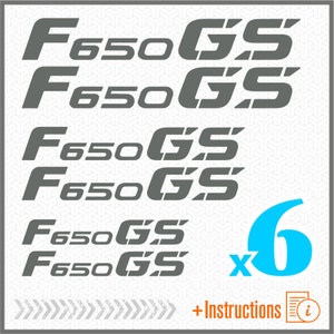 Peut inclure: Six autocollants en vinyle gris avec le texte "F650GS" dans une police audacieuse et stylisée. Les autocollants sont disposés en deux rangées de trois. Le texte "6 x" et le chiffre "6" en bleu clair sont affichés sous les autocollants.