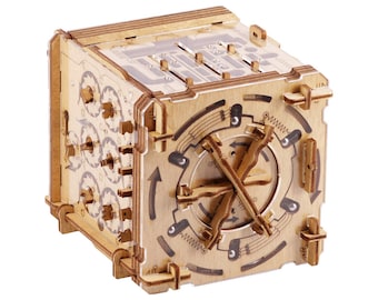 May include: A wooden puzzle box with a intricate design and multiple gears. The box has a clear acrylic window on one side, revealing the inner workings of the puzzle.