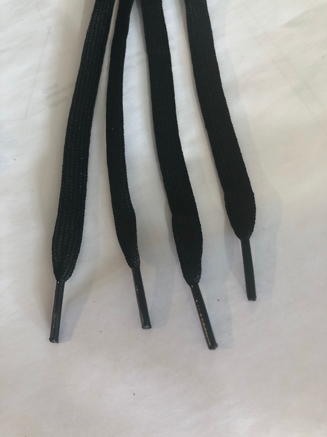black shoelaces with silver tips