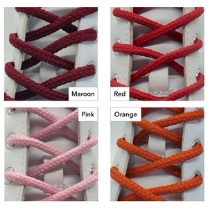 Op de afbeelding: Vier paar veters in verschillende kleuren: bordeauxrood, rood, roze en oranje. De veters zijn geknoopt in een kruispatroon op een witte schoen.