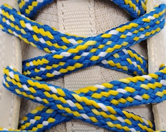 May include: Close-up of blue, yellow, and white shoelaces woven together in a criss-cross pattern.