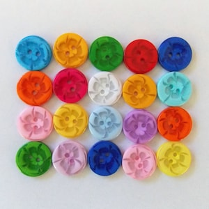 May include: Assortment of 20 colorful plastic buttons with a flower design. The buttons are in various colors, including red, blue, green, yellow, orange, pink, and white.