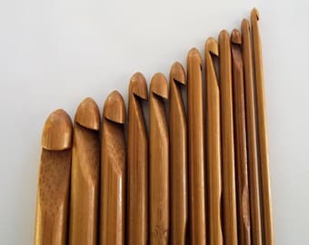 May include: A set of 12 wooden crochet hooks in various sizes. The hooks are made of natural bamboo and have a smooth, polished finish.