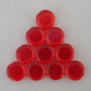 May include: Ten red, round, plastic game pieces arranged in a triangular shape.
