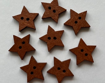 May include: Eight brown wooden star-shaped buttons with two holes each.