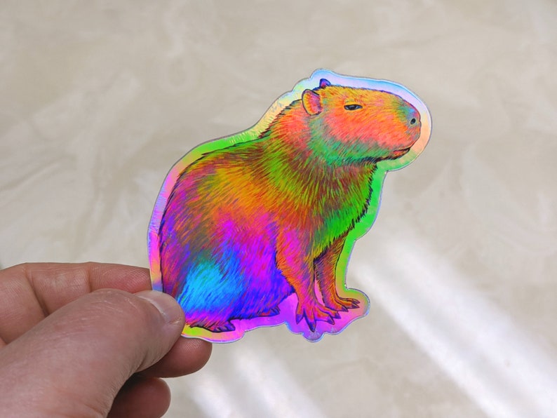 Psychedelic rainbow capybara vinyl die cut holographic sticker