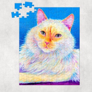 May include: A white cat with orange markings on its face, painted in a colorful, abstract style. The cat's fur is depicted with a variety of colors, including pink, blue, and yellow. The cat's eyes are blue and its nose is pink. The background is a bright blue.