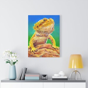 Canvas art print wall art portrait of a yellow bearded dragon lizard with a bright green and blue background.