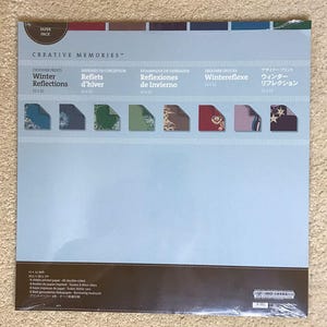 May include: A Creative Memories Winter Reflections designer paper pack. The pack includes 12 x 12 inch (30.5 x 30.5 cm) double-sided printed sheets with various winter-themed designs. The package features text in multiple languages.