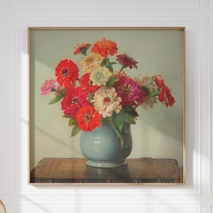 May include: A vintage painting of a bouquet of red, pink, and white zinnias in a blue vase on a wooden table.