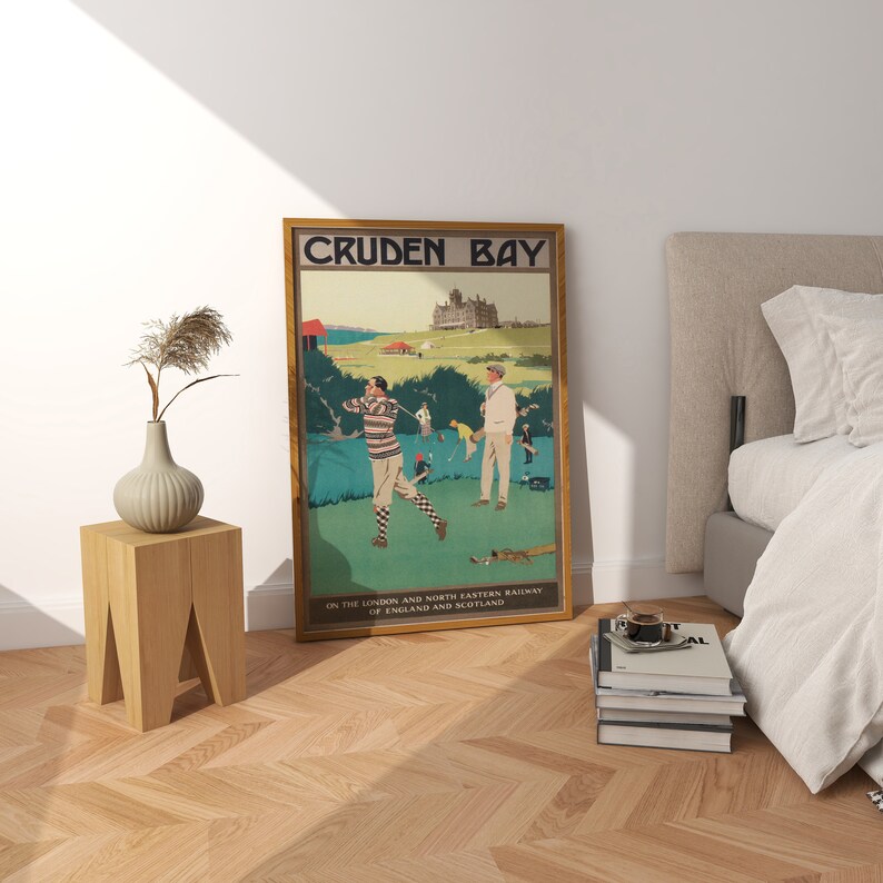 May include: A vintage travel poster advertising Cruden Bay, a golf course in Scotland. The poster features two golfers on a green course with a large building in the background. The text on the poster reads "Cruden Bay" and "On the London and North Eastern Railway of England and Scotland."