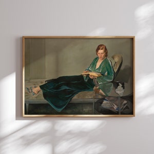 May include: A painting of a woman in a green velvet robe reclining on a chaise lounge and reading a book. She is wearing a pair of blue shoes and has red hair. The painting is set in a room with a side table and a vase of flowers.