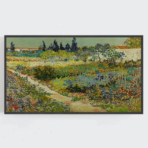 May include: A framed print of a garden scene, with a path winding through a colourful array of flowers and foliage. The artwork, in a rectangular black frame, features greens, blues, yellows, and reds, creating a sense of nature and tranquility.