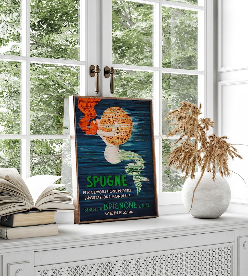 May include: Vintage poster advertising sponges with a mermaid holding a large sponge. The poster is in blue, green, yellow, and red colors. The text reads "Spugne,  Pelica Lavorazione Propria, Esportazione Mondiale, Benedetto Brignone & Figli, Venezia".
