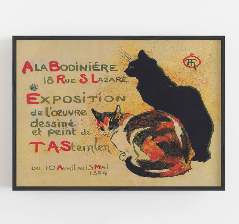 May include: A framed vintage poster featuring two cats and French text. The poster has a tan background with red and green text. The cats are black and calico. The text includes the artist's name, the location, and the dates of the exhibition.