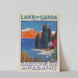 May include: Vintage travel poster for Lake Garda, Italy, featuring a scenic landscape. The poster has text that reads "Lake of Garda, Golf Links, Gardone Riv. and Fasano." The artwork depicts a lake, mountains, and trees in vibrant colors.