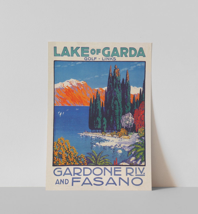 May include: Vintage travel poster for Lake Garda, Italy, featuring a scenic landscape. The poster has text that reads "Lake of Garda, Golf Links, Gardone Riv. and Fasano." The artwork depicts a lake, mountains, and trees in vibrant colors.