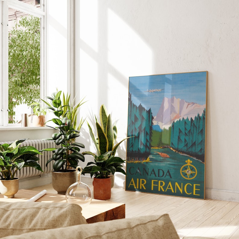 May include: A vintage travel poster featuring a scenic landscape with mountains, trees, and a river. The poster is in blue, green, and yellow tones and has the text "CANADA AIR FRANCE" at the bottom.