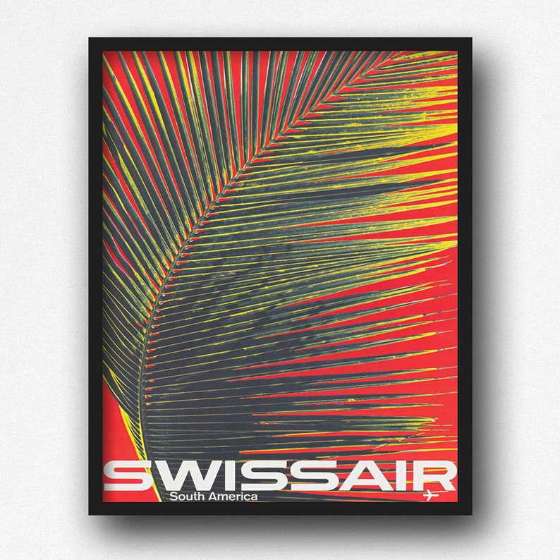 May include: A framed poster with a vibrant design. The artwork features a large palm leaf in shades of green and yellow against a red background. The poster includes the text "SWISSAIR South America" in white, with a small airplane icon.
