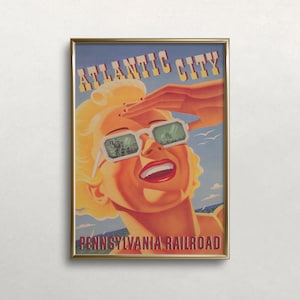 Puede incluir: Cartel de viaje vintage enmarcado para Atlantic City. Muestra a una mujer rubia con gafas de sol, protegiéndose los ojos. El cartel incluye el texto "Atlantic City" y "Pennsylvania Railroad". La mujer tiene pintalabios rojo y una tez bronceada.