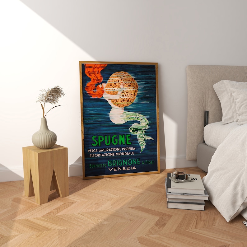 May include: Vintage poster advertising Spugne Brignone & Figli, a brand of sponges from Venice, Italy. The poster features a mermaid holding a large sponge, with the text "Spugne" and "Peica Lavorazione Propria Esportazione Mondiale" in green and black.