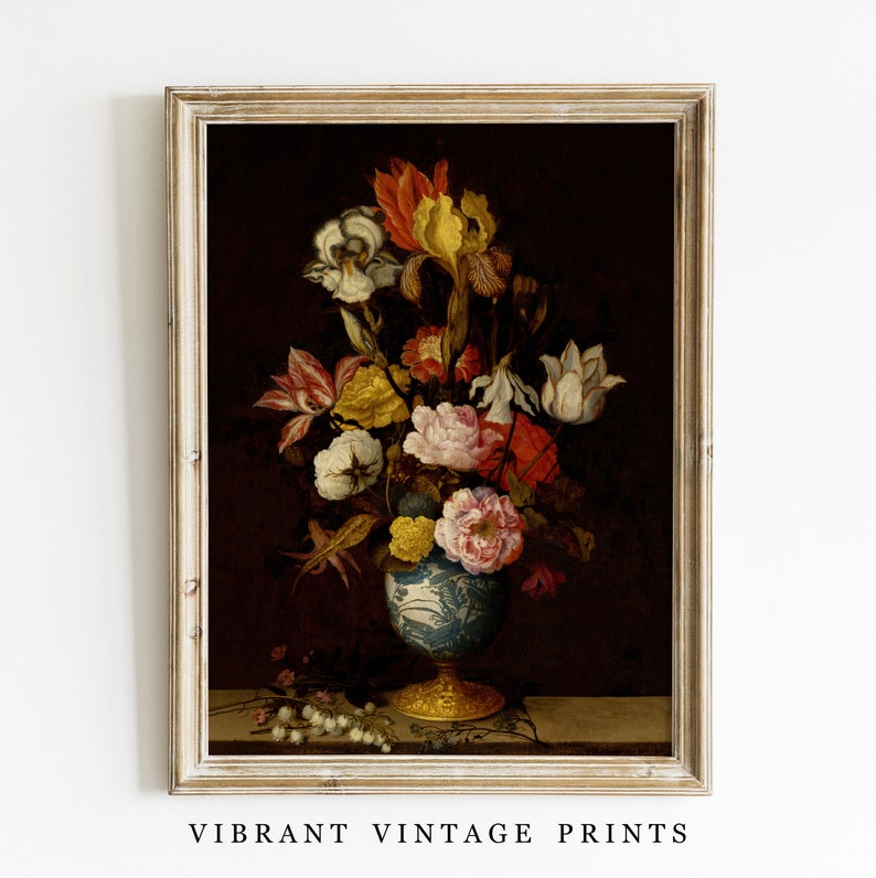 May include: A framed vintage print featuring a still life of colorful flowers in a blue and white vase with a gold base. The flowers include red, yellow, and white blooms against a dark background. The text "VIBRANT VINTAGE PRINTS" is at the bottom.