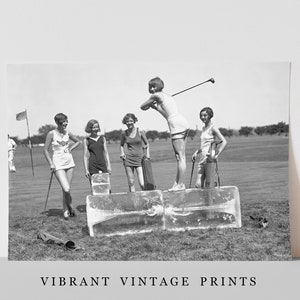 May include: Five women in vintage clothing stand on a golf course. They are holding golf clubs and bags. The women are standing on blocks of ice. The image is in black and white.