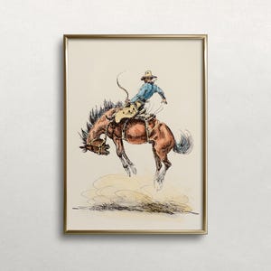 May include: A framed illustration of a cowboy riding a bucking horse. The cowboy is wearing a blue shirt, brown trousers, and a hat. The horse is brown and white and is kicking its legs in the air. The illustration is done in a vintage style with black ink and watercolour.