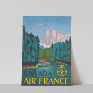 May include: Vintage travel poster advertising Air France flights to Canada. The poster features a blue sky, a mountain range, a river, and a plane flying overhead. The text "CANADA AIR FRANCE" is in yellow letters at the bottom of the poster.