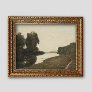May include: An antique landscape painting in a gold ornate frame. The artwork depicts a river scene with trees on the banks and a soft, muted color palette. The frame has detailed carvings, adding to the vintage aesthetic.