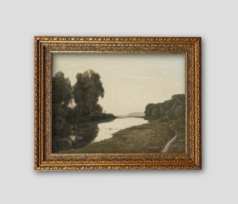 May include: An antique landscape painting in a gold ornate frame. The artwork depicts a river scene with trees on the banks and a soft, muted color palette. The frame has detailed carvings, adding to the vintage aesthetic.