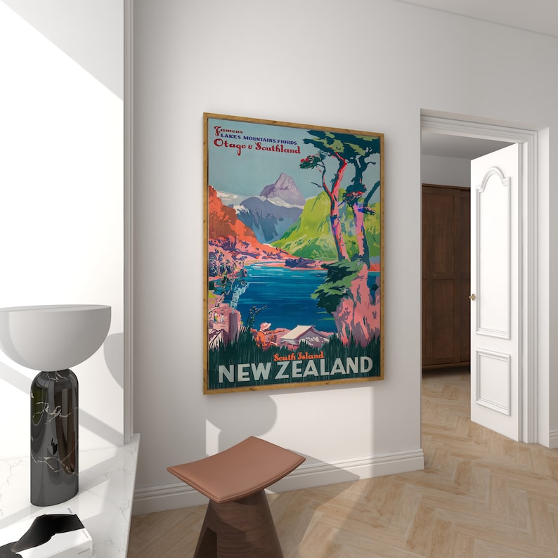 May include: Vintage travel poster featuring a scenic landscape with mountains, a lake, and trees. The poster is titled "Famous Lakes Mountains Forests Otago & Southland South Island NEW ZEALAND".