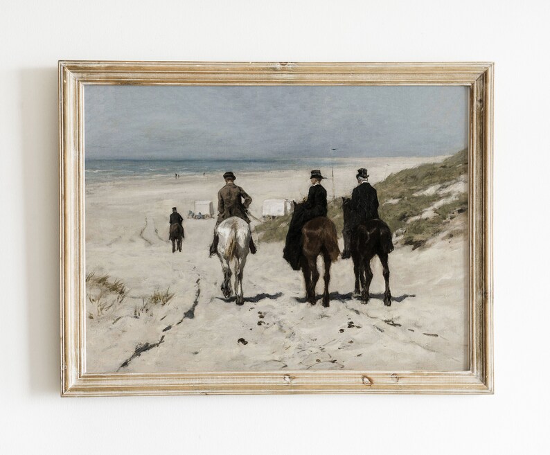 May include: An antique framed print depicts a beach scene with three people riding horses along the sandy shore. The artwork features a muted color palette with a cloudy sky and distant figures, evoking a sense of nostalgia.