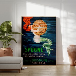 May include: Vintage poster advertising "Spugne" brand sponges. The poster features a mermaid with red hair holding a large sponge. The text on the poster reads "Spugne, Pesca Lavorazione Propria, Esportazione Mondiale, Benedetto Brignone & Figli, Venezia."