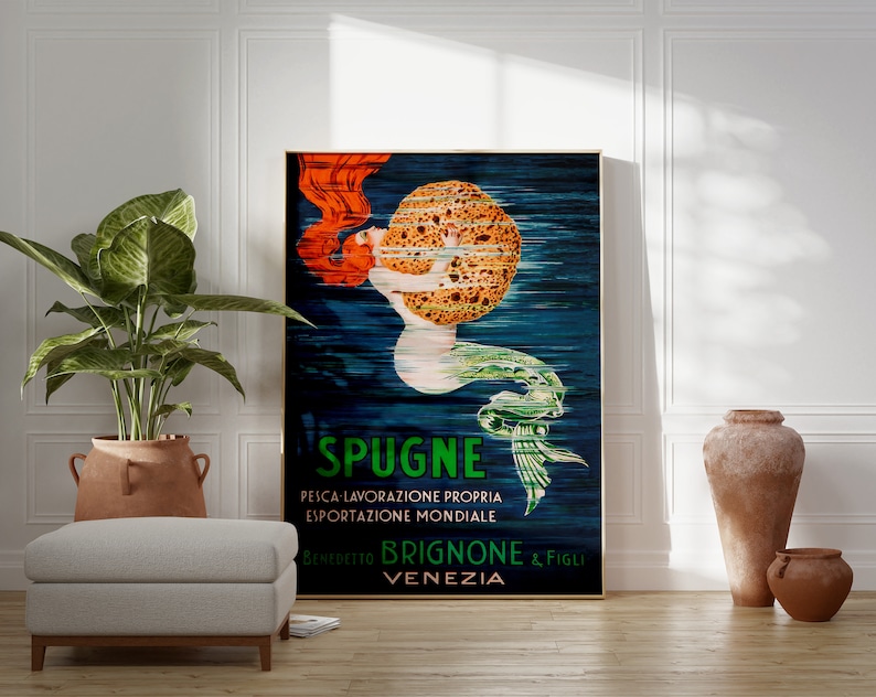 May include: Vintage poster advertising "Spugne" brand sponges. The poster features a mermaid with red hair holding a large sponge. The text on the poster reads "Spugne, Pesca Lavorazione Propria, Esportazione Mondiale, Benedetto Brignone & Figli, Venezia."