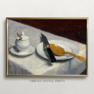 Pode incluir: Impressão de arte vintage com natureza morta. Um prato branco com uma faca e uma colher dourada. Uma pequena açucareiro branco com tampa sobre um pires. A cena se passa sobre uma toalha de mesa branca com fundo vermelho escuro. O texto "VIBRANT VINTAGE PRINTS" está na parte inferior.