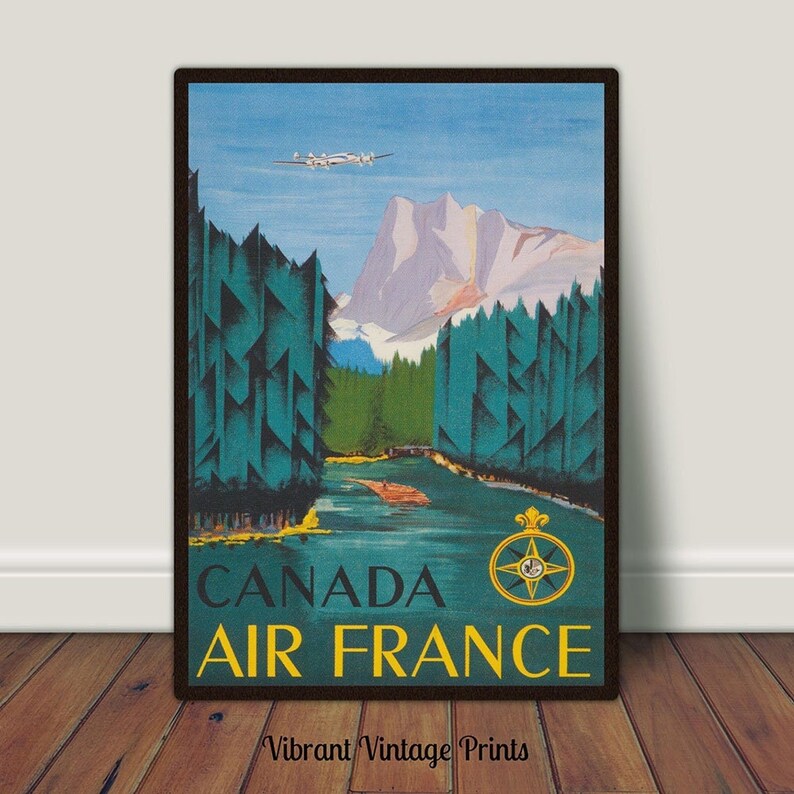 May include: Vintage travel poster advertising Air France flights to Canada. The poster features a blue sky with a white airplane flying over a mountain range and a river flowing through a forest. The text "CANADA AIR FRANCE" is in yellow and blue letters.