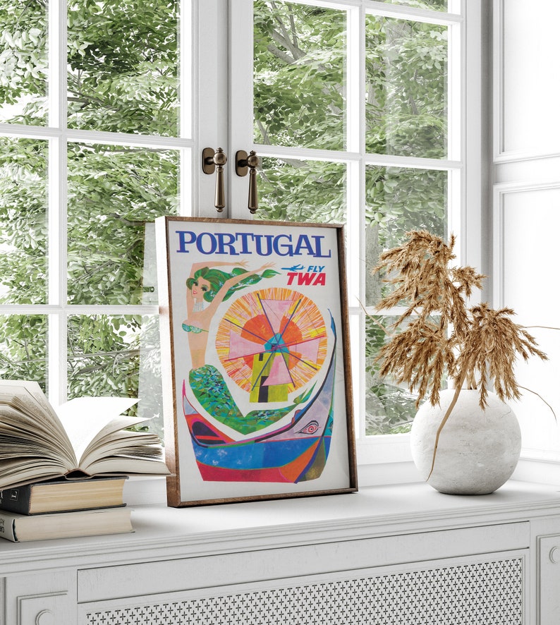 May include: Vintage travel poster advertising a trip to Portugal with TWA airlines. The poster features a colorful illustration of a mermaid with a windmill in the background. The text "FLY TWA" is in the upper right corner.