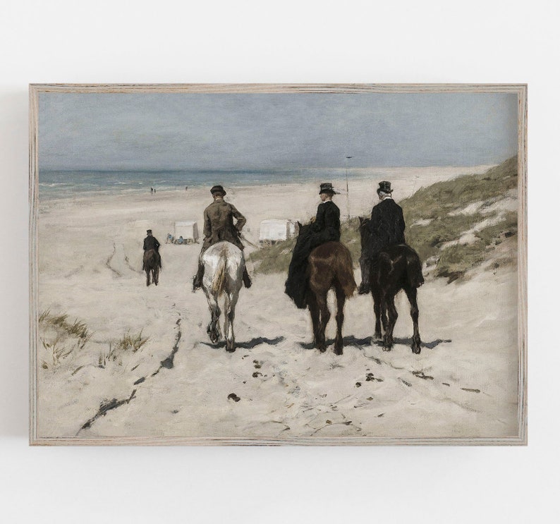 May include: A framed vintage print depicts three people riding horses on a sandy beach, with a fourth figure walking in the distance. The artwork features a muted color palette of blues, grays, and browns, evoking a sense of nostalgia.