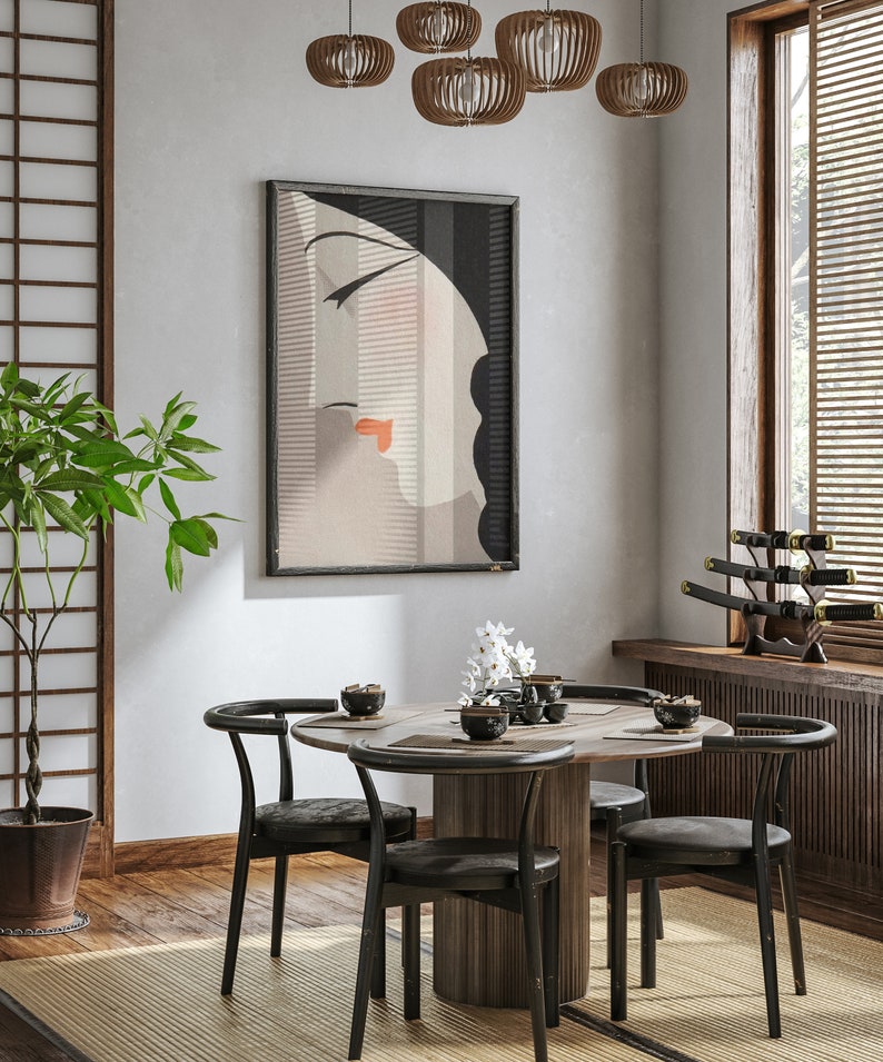 May include: A dining room scene featuring a round wooden table with four black chairs. A framed art print of a woman's face hangs on the wall. Decorative wooden pendant lights and a Japanese-style screen add to the room's aesthetic.