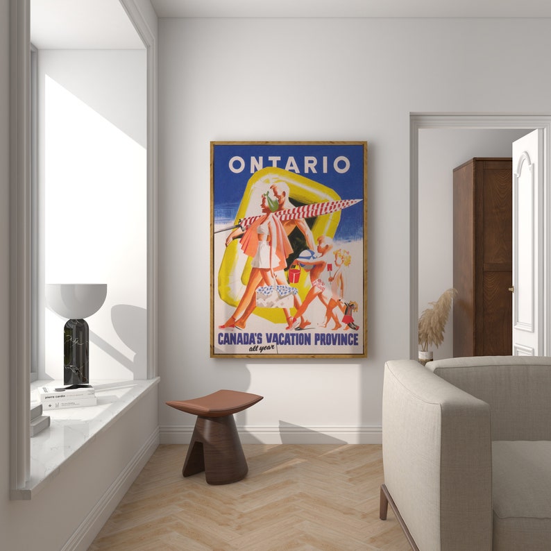 May include: A framed vintage travel poster for Ontario, Canada, featuring a retro illustration of people on a beach. The poster has a blue background with the word "ONTARIO" at the top and "CANADA'S VACATION PROVINCE all year" at the bottom.