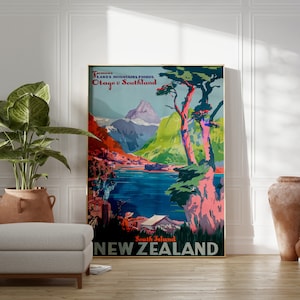 May include: A vintage travel poster advertising New Zealand's South Island. The poster features a colorful illustration of mountains, a lake, and a large tree with pink and green foliage. The text on the poster reads "South Island NEW ZEALAND" and "Fiords Lakes Mountains Fiords Otago & Southland".