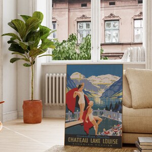 May include: Vintage travel poster for Chateau Lake Louise in the Canadian Rockies. The poster features a blue and green landscape with mountains, a lake, and two women in bathing suits standing on a dock. The text on the poster reads "Canadian Pacific Chateau Lake Louise Canadian Rockies".