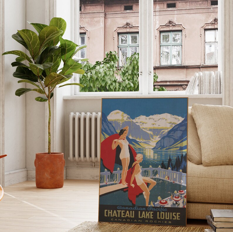 May include: Vintage travel poster for Chateau Lake Louise in the Canadian Rockies. The poster features a blue and green landscape with mountains, a lake, and two women in bathing suits standing on a dock. The text on the poster reads "Canadian Pacific Chateau Lake Louise Canadian Rockies".