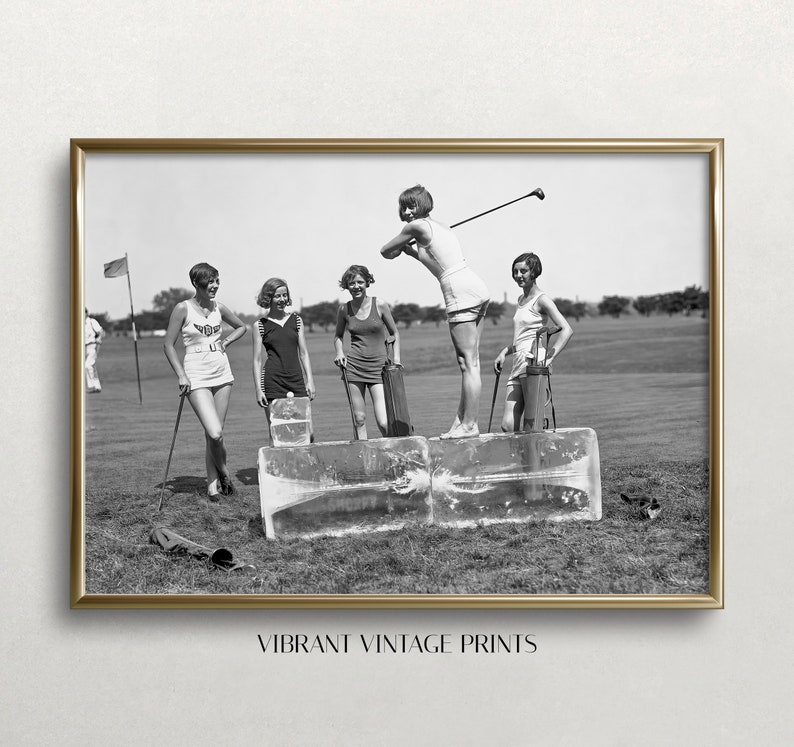May include: Black and white photograph of five women playing golf on a golf course. The women are wearing 1920s clothing and are standing on blocks of ice. One woman is swinging a golf club.