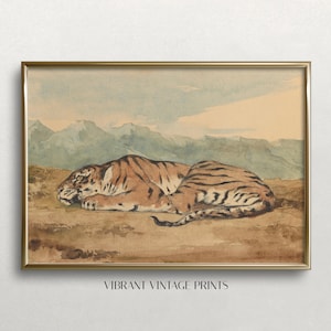 May include: A framed watercolour print depicting a tiger lying down. The tiger has brown and black stripes. The background shows mountains and a light blue sky. The text "VIBRANT VINTAGE PRINTS" is at the bottom.