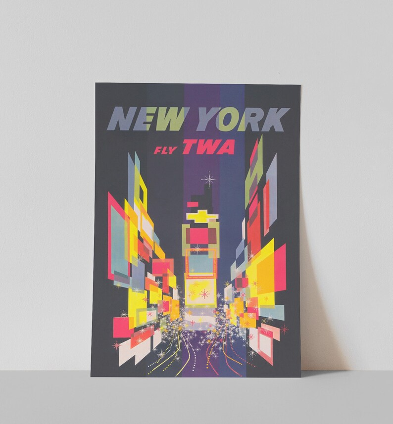 May include: A vintage travel poster advertising flights to New York City with the airline TWA. The poster features a stylized image of Times Square at night with bright lights and a star in the sky. The text on the poster reads "NEW YORK FLY TWA".