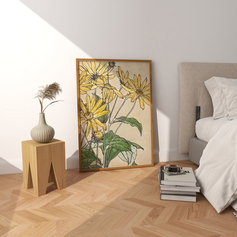 May include: A framed print of a botanical illustration featuring yellow flowers with green leaves on a beige background.