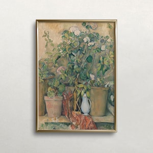 May include: An oil painting in a gold frame depicts a still life of potted plants and a white pitcher. The plants have green leaves and white and pink flowers. A red and orange patterned cloth is draped over a ledge.